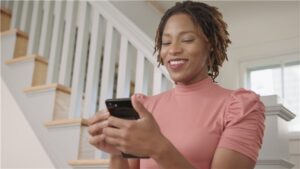 A lady using a phone | HVAC Financing