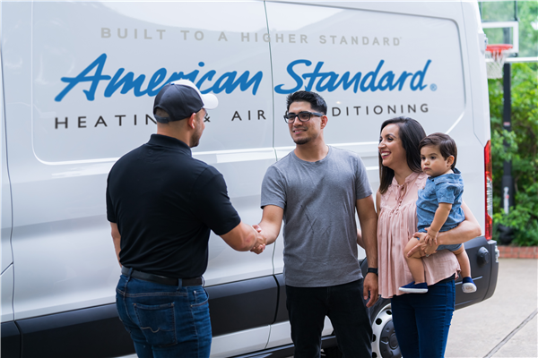 A family of three with an HVAC technician. | HVAC Service Experts